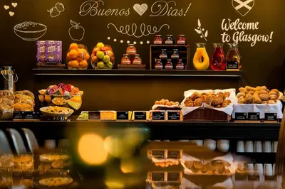 a bakery with a bunch of different types of food at Motel One Glasgow in Glasgow