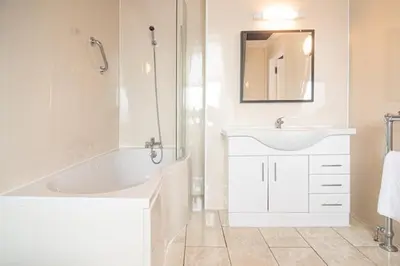 a white bathroom with a tub and a sink at Barriemore Oban in Oban