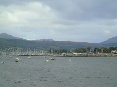 a group of boats in a large body of water at Snug - Meadhan Apartment in Helensburgh