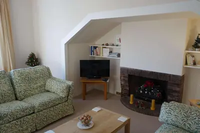 a living room with a couch and a fireplace at Sophisticated Edinburgh Apartment in City Centre in Edinburgh