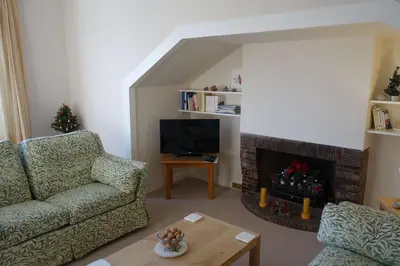 a living room with a couch and a fireplace at Sophisticated Edinburgh Apartment in City Centre in Edinburgh