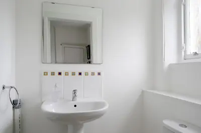 a white bathroom with a sink and a mirror at Stylish 2 Bedroom Bruntsfield Apartment in Edinburgh in Edinburgh