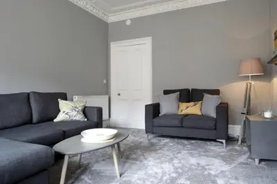 a living room with two couches and a table at Stylish 2 Bedroom Bruntsfield Apartment in Edinburgh in Edinburgh