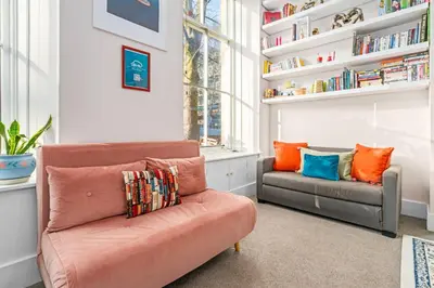 a living room with a couch and a chair at Unique Victorian Home in Glasgow in Glasgow