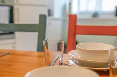 a table with a plate and a bowl and a glass at Unique Victorian Home in Glasgow in Glasgow