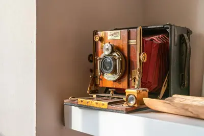 an old camera sitting on top of a shelf at Unique Victorian Home in Glasgow in Glasgow