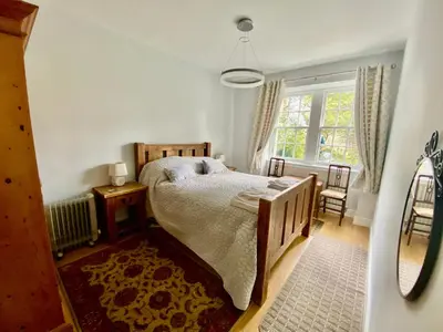 a bedroom with a bed and a window at Underneath the Arches in Penicuik