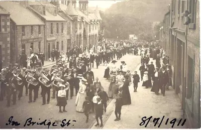 an old photo of a crowd of people walking down a street at Underneath the Arches in Penicuik