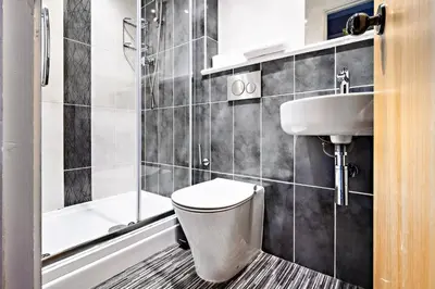 a bathroom with a toilet and a sink at Glasgow City Flats in Glasgow