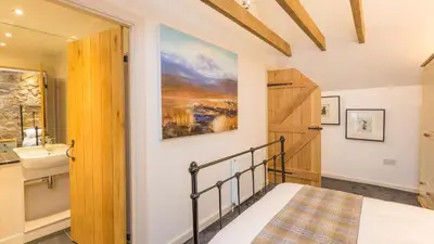 a bedroom with a bed and a sink at Hayloft Edinburgh in Edinburgh