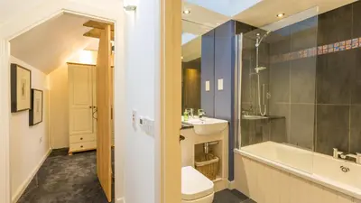 a bathroom with a toilet and a sink and a tub at Hayloft Edinburgh in Edinburgh