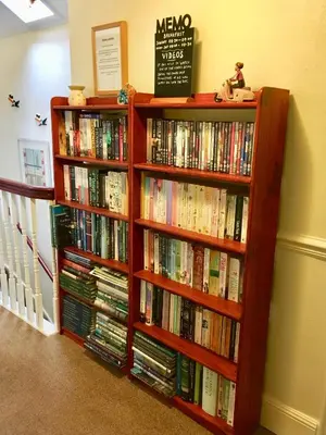 two book shelves filled with books in a room at TwoStones in Arrochar