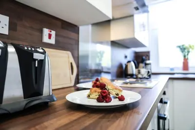 a plate of food on a counter in a kitchen at Meadowburn View in Wishaw