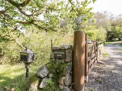 a sign on a stone wall next to a road at The Log Cabin in Kilmore