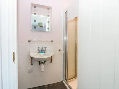 a bathroom with a sink and a shower at Driftwood Cottage in Craignure