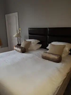 a large white bed with two pillows on it at Ardshiel Hotel in Campbeltown