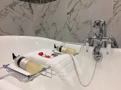 a bathroom with a bath tub with a faucet at Skyfall Glencoe at Creag ant Sionnaich Glencoe Ballachulish Highlands Near Fortwilliam in Glencoe