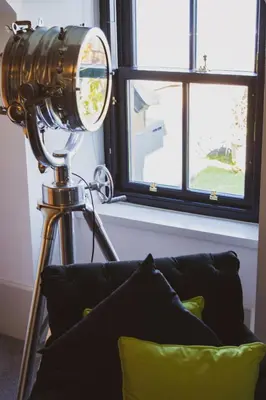 a camera on a tripod next to a couch at The Douglas Hotel in Brodick