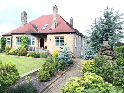 a house with a garden in front of it at The Cairn Residence in Edinburgh