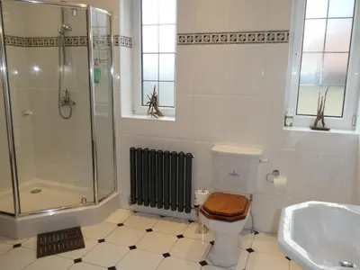 a bathroom with a shower and a toilet and a sink at The Cairn Residence in Edinburgh