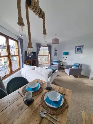 a living room with a table and a couch at The Clamshell, Oban in Oban