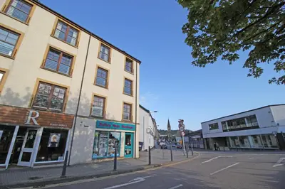 a building on the corner of a city street at The Clamshell, Oban in Oban