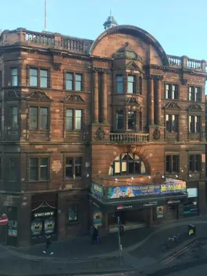 a large brick building on a city street at Menzies Apartments in Edinburgh