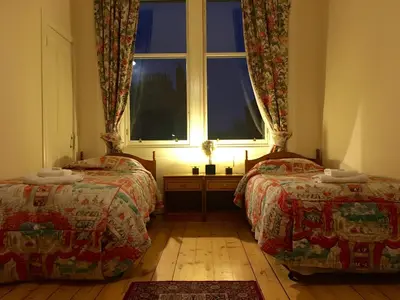 a bedroom with two beds and a window at Menzies Apartments in Edinburgh