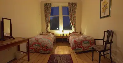 a bedroom with two beds and a window at Menzies Apartments in Edinburgh