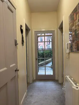 a hallway with a door leading to a balcony at The cosy courtyard in Edinburgh