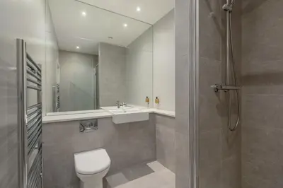 a bathroom with a toilet and a sink and a shower at Destiny Scotland Apartments at Canning Street Lane in Edinburgh