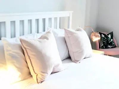 a white bed with white pillows on it at Stylish City Centre Apartments - D Terrace Residence in Edinburgh