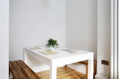 a white table with a potted plant on it at Stylish City Centre Apartments - D Terrace Residence in Edinburgh