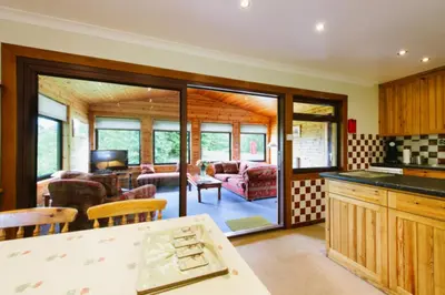 an open kitchen and living room with a living room at The Buzzard Lodge 2 bedroom sleeps up to 4 in Crianlarich