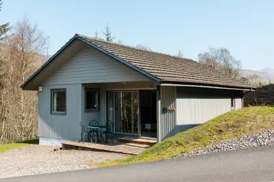 a small shed with a table in it at Fisher Lodge sleeps up to 2 in Crianlarich
