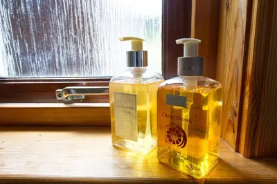 two bottles of soap sitting on a window sill at Kingfisher Lodge with sensational loch views in Crianlarich