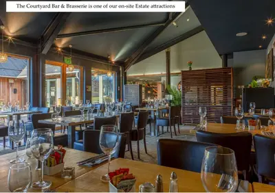 a restaurant with wooden tables and chairs and wine glasses at Mains of Taymouth Country Estate 5* Maxwell Villas in Kenmore