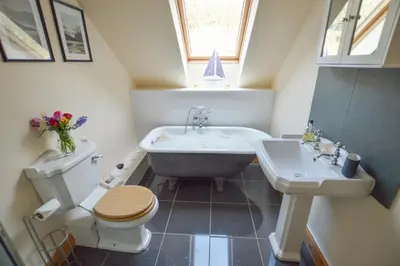 a bathroom with a tub and a toilet and a sink at Feochan Bheag in Oban