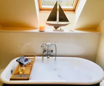 a bath tub with a sail boat on a window at Feochan Bheag in Oban