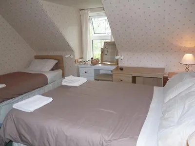 a bedroom with two beds and a window at St Annes Guest House in Oban