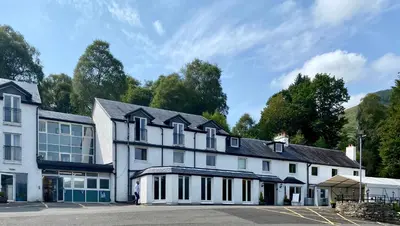 a large white building with a lot of windows at The Inn on Loch Lomond in Luss