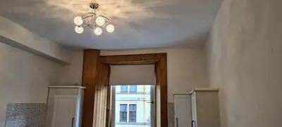 a ceiling with a chandelier in a room at Rozina Apartment in Paisley