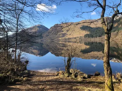 a view of a lake in the mountains at The Wee Ludging - A Cosy Riverside Cottage for Two in Dunoon