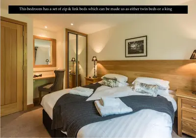 a bedroom has a large bed with white pillows which can be made with sheets at Mains of Taymouth Country Estate 5* Gallops Apartments in Kenmore
