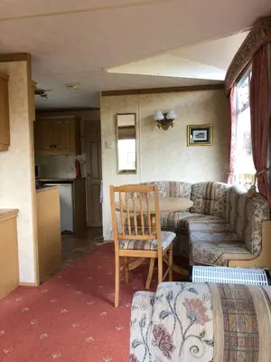 a living room with a couch and a table at 35 Glenfinart Park in Dunoon