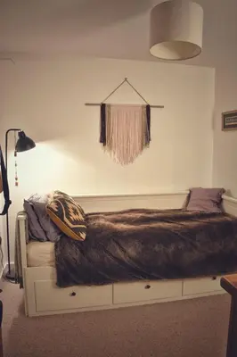 a bed with a brown blanket on it in a room at Cosy Cottage in Glencoe