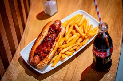 a hot dog and french fries and a bottle of soda at Kick Ass Grassmarket (18+) in Edinburgh