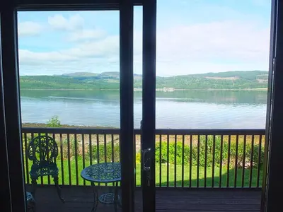 a view of a lake from a door at Trefoil Holiday Home in Strachur