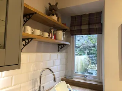 a kitchen with a sink and a window at The Cottage in Dunblane
