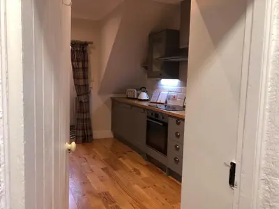 a kitchen with a sink and a stove top oven at The Cottage in Dunblane